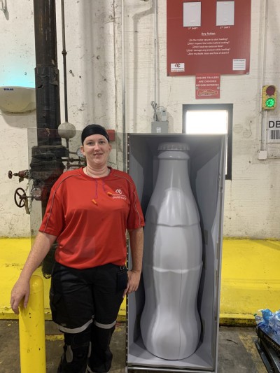 Marie Whitson, Machine Operator, with the Recognition Roadtrip Bottle at the Quapah facility on Oct. 25, 2021.