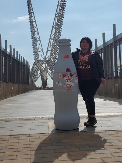 Angela Nunez, POS Clerk, on the bridge to Scissortail Park, a 70-acre urban oasis stretching from downtown Oklahoma City to the shore of the Oklahoma River.