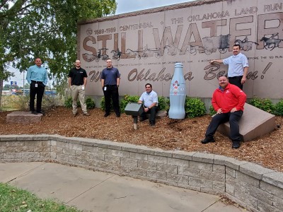 Stillwater Distribution Center Managers and ORMs take the Recognition Roadtrip Bottle to “Where Oklahoma Began” at the official welcome area marked by the Stillwater City Sign on Oct. 20, 2021.