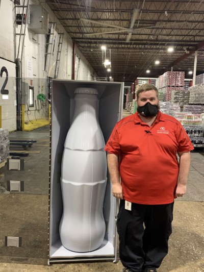 Zachary Starritt, Shipping and Receiving Supervisor, with the Recognition Roadtrip Bottle at the Quapah facility on Oct. 25, 2021.