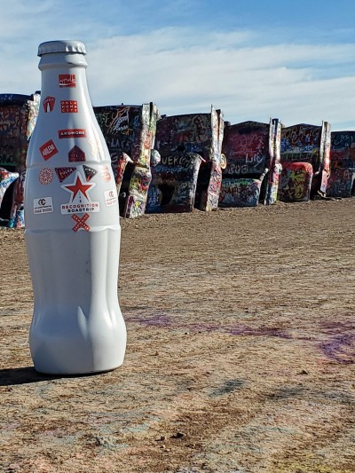The Recognition Roadtrip Bottle posing in front of the famed half-buried Cadillacs. Cadillac Ranch was created in 1974 and later made popular by the Bruce Springsteen 1980 classic album The River where his song “Cadillac Ranch” references the ten buried Cadillacs in Amarillo, Texas.