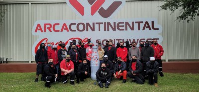 Abilene frontline heroes in front of the Arca Continental CCSWB sign with the Recognition Roadtrip Bottle on Nov. 8, 2021. Arca Continental, the parent company of Coca-Cola Southwest Beverages, is excited to celebrate the 5-year anniversary of CCSWB.