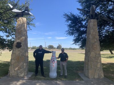 John Gardener, Warehouse Manager I, and Garret Dussia, Maintenance Manager III, at Dyess Memorial Park with the Recognition Roadtrip Bottle. CCSWB is honored to have amazing Veterans, like Dussia and Gardener, on our team!