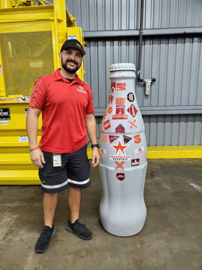 Javier Vela, Lead Driver, with the Recognition Roadtrip Bottle at the El Campo distribution center on Jan. 6, 2022.