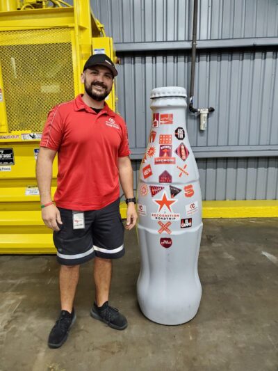 Javier Vela, Lead Driver, with the Recognition Roadtrip Bottle at the El Campo distribution center on Jan. 6, 2022.