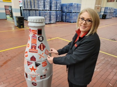 Amber Noyola, Sales Execution Manager, shows her Beaumont pride as she puts the customized city sticker on the Recognition Roadtrip Bottle on Jan. 19, 2022.
