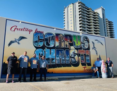 CCSWB heroes welcome the Recognition Roadtrip Bottle to Corpus Christi, Texas at the Greetings mural downtown on March 14, 2022. The mural, designed in 2018 by local artist Jeremy Flores, was a gift to the city by IT services company, Richline Technical Services. The mural was inspired by a Richline executive’s trip to Valparaiso, Chile, a beautiful coastline city covered with murals.