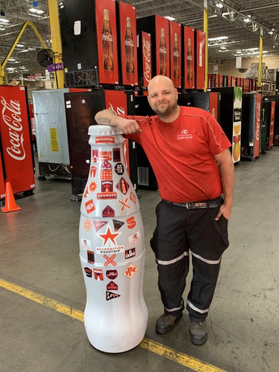EFC hero, Ryan Girouard, Technician, with the Recognition Roadtrip Bottle on Feb. 22, 2022.