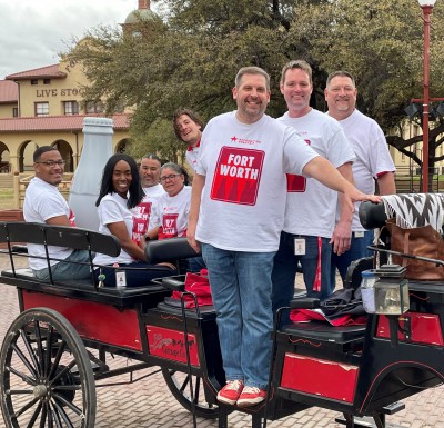 Fort Worth heroes take the Recognition Roadtrip Bottle for a carriage ride through the Fort Worth Stockyards on March 22, 2022. At the height of WWI in 1917, the Stockyards served as the largest horse and mule market in the world, drawing military officers from Allied countries who purchased animals for the war effort.