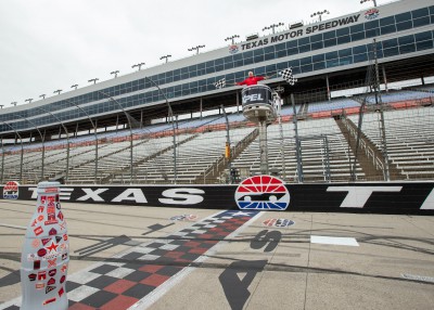 “And the winner of the Recognition Roadtrip Race is…” The Recognition Roadtrip Bottle crosses the finish line of Texas Motor Speedway as Greg Artkop, Director of Communications, waves the checkered flags to signify the end of the race.