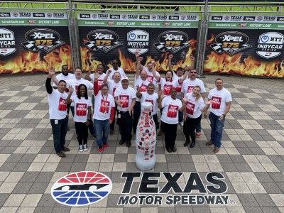 Everyone is a winner at CCSWB! Fort Worth heroes celebrate with the Recognition Roadtrip Bottle in Victory Lane at Texas Motor Speedway on March 22, 2022. Victory Lane marks the space where race winners celebrate a successful day by donning (what else?) cowboy hats surrounded by artificial flames and cheering fans.