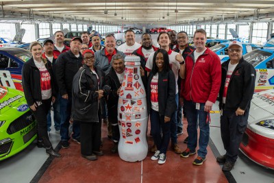 Fort Worth and the Recognition Roadtrip Bottle meet Rob Ramage, the General Manager of Texas Motor Speedway, in its famed garage on March 22, 2022. Texas Motor Speedway boasts more than 44,000 square feet of garage space that visitors can enter when not in use to see retired vehicles or vehicles being repaired.