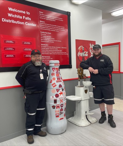 Wichita Falls heroes, Bryce Smith, Warehouse Lead, and Eddie Smith, Bulk Driver, welcome the Recognition Roadtrip Bottle to their distribution center on March 28, 2022.